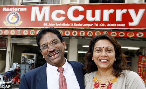 Owners of McCurry in front of their restaurant 